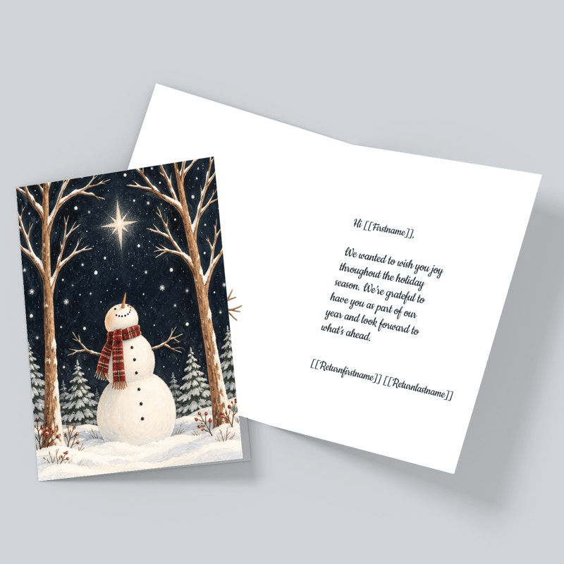 Christmas card with snowman looking up to a star in the sky